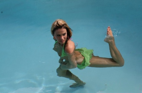 Swimming in a pool, amateur Addison St James releases her little legs from a bikini top.