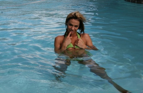 In a pool, amateur Addison St James releases her perky tits from a bikini while dancing.