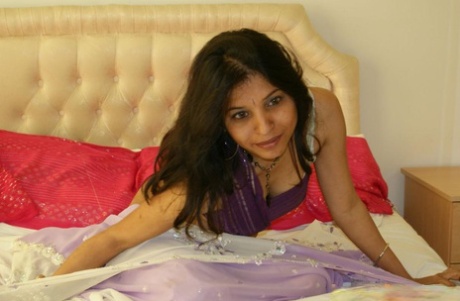 MILF Kavya Sharma of India exposes herself naked on a bed while competing solo.