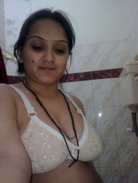An Indian student who is overweight displays her bare chest using a brace.
