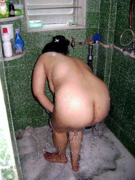 While showering, the Indian fatty cleans up her clothes.