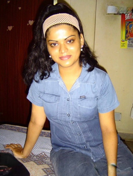 Neha, the chubby Indian girl from India, displays her breasts on a dresser while naked.