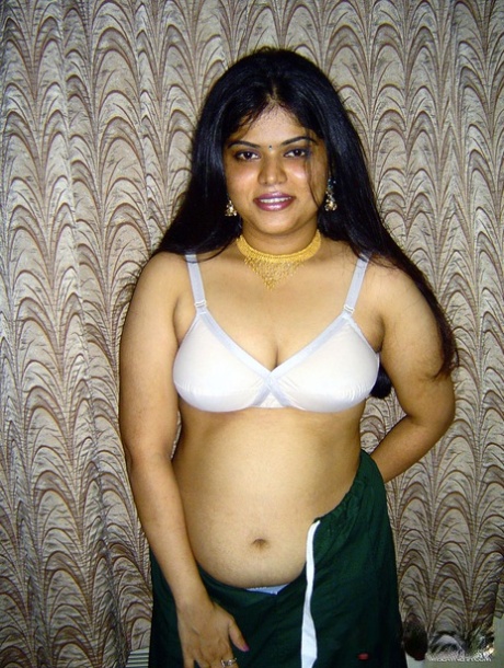 Neha, a small Indian girl, releases her breasts from the white brassiere.