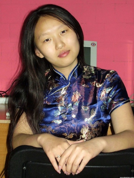 At the request of her guy, a young Asian girlfriend poses with clothes on and without them on.