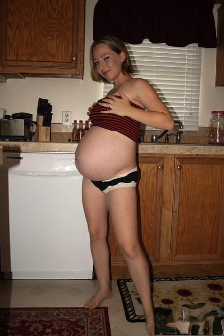 Pregnant amateur removes a tube top before slipping out of sexy panties - PornHugo.net