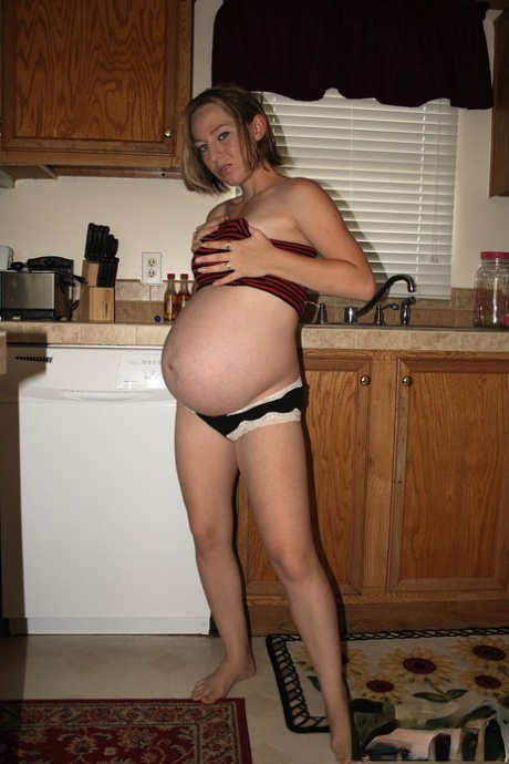 Pregnant amateur removes a tube top before slipping out of sexy panties - PornHugo.net
