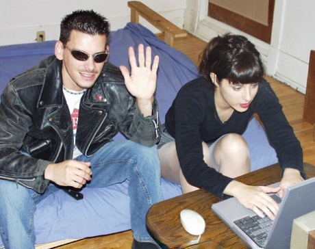 A horny duo is seen crawling on a bed after viewing pornographic material on a laptop.