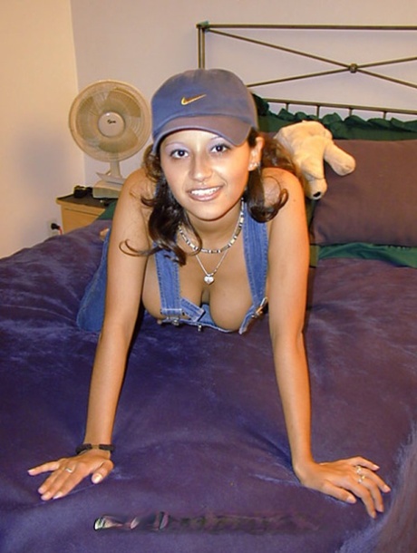 A cute little girl of Latina origin exposes her great tits while banning herself in a ball cap.