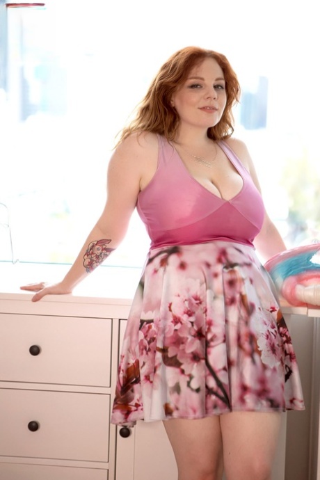 In her bedroom, BBW Avalon, a redheaded Australian, exposes herself for a photo.