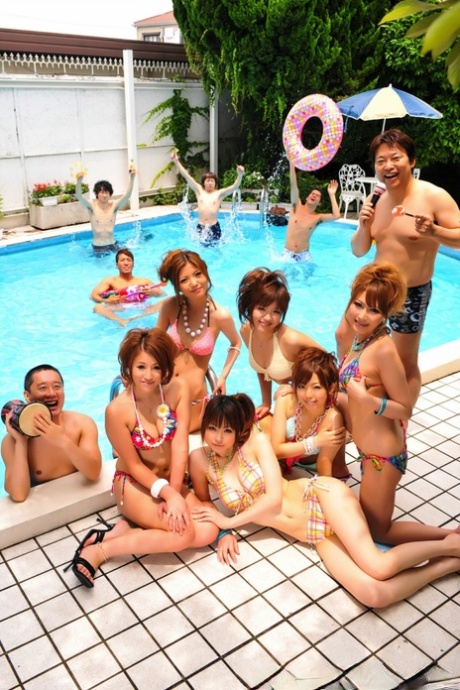 During the summer, Japanese bikini models gather on a poolside patio to take part in group shoots.
