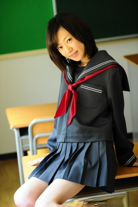A Japanese student who is not legally bound bares her knees in the school uniform she wears.