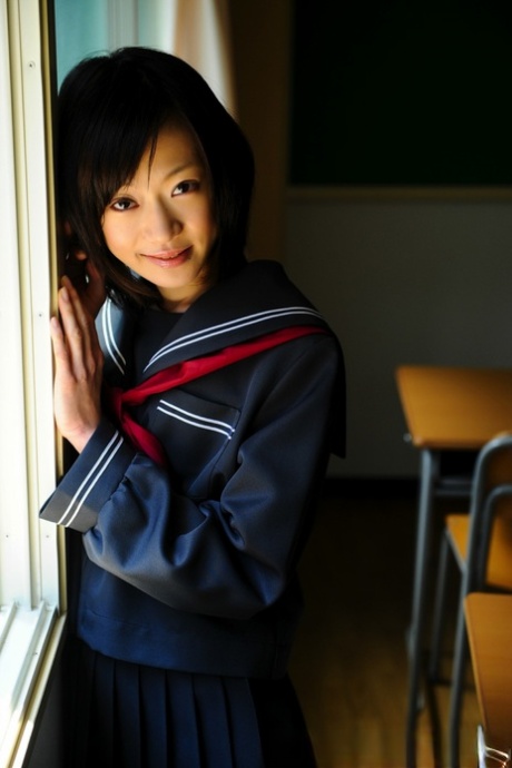 This is a rare example of a Japanese student in her school uniform who wears the "bare" on her knees.