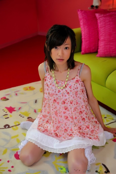 Japanese girl with a small, attractive face models herself wearing socks without nude attire at knees.