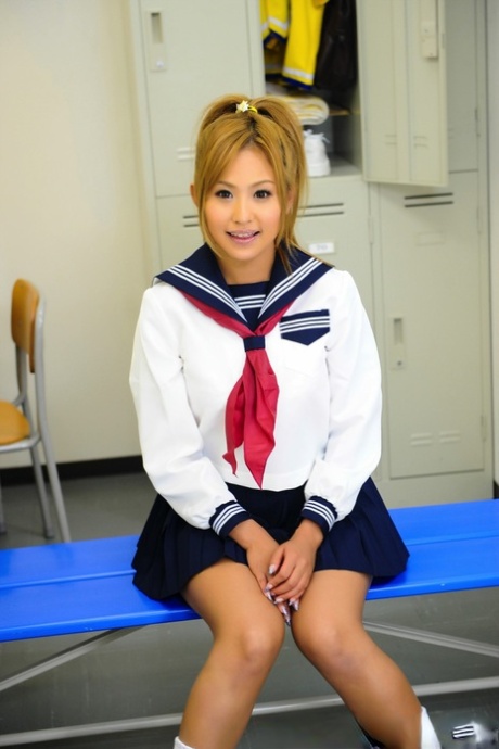 Superb: This handsome Japanese student poses for a photo on the bench in uniform with her cute face across the top.