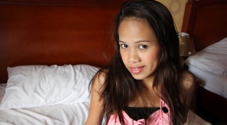A POV blowjob is performed on a slim Asian amateur's face while wearing a jig.