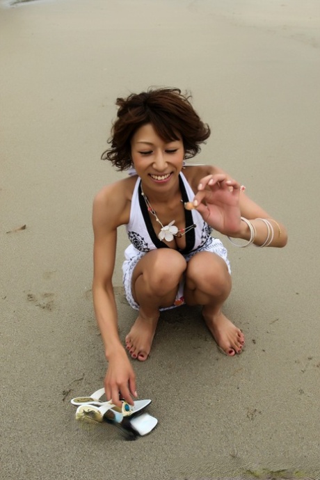 Japanese Girl Wears A Bikini While Playing In The Ocean During A Beach Holiday