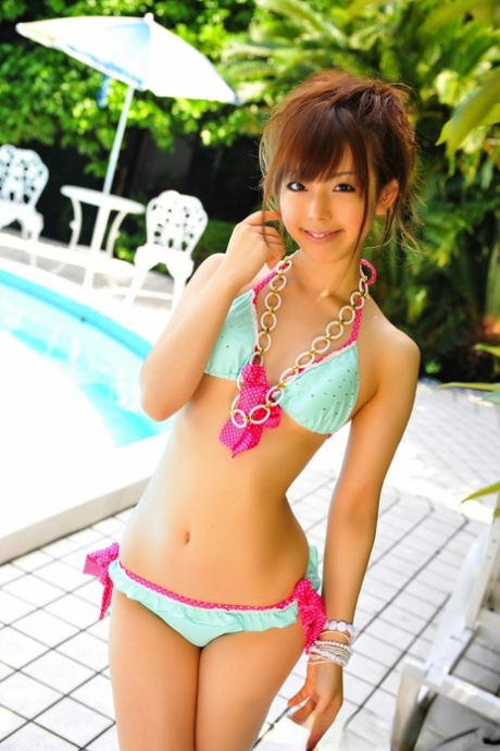 Adorable Japanese Girl Models A Pretty Bikini On A Poolside Patio