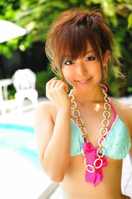 Adorable Japanese Girl Models A Pretty Bikini On A Poolside Patio