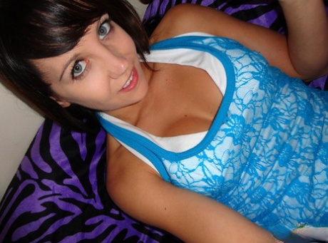 Dark haired teen Andi Land masturbates with a vibrator during self shot action