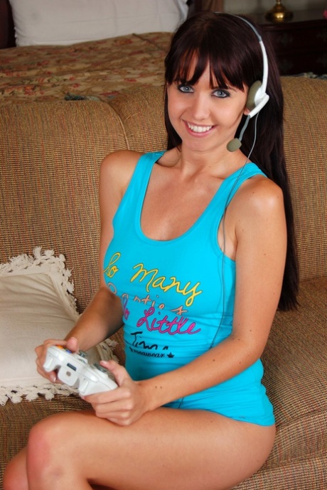Young Brunette Chrissy Exposes Her Small Tits And Pussy While Gaming On A Sofa