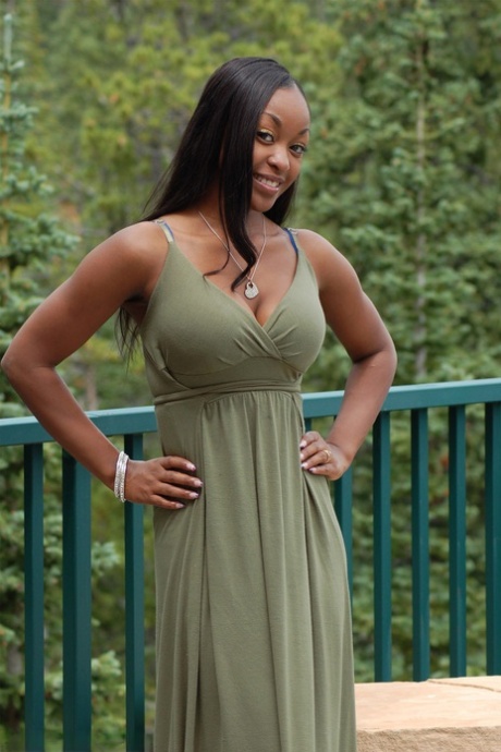 Ebony Amateur Amber Releases Her Big Tits From A Long Dress On A Balcony