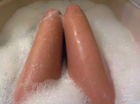 Teen amateur Andi Land shows off her nude body in the bubble bath.