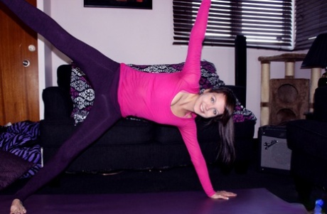 Doing yoga with her bare hands, Andi Land, a young non-professional, displays her ass during the practice.