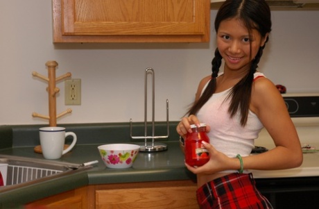 A young lady removes her plaid skirt and wears charming panties.