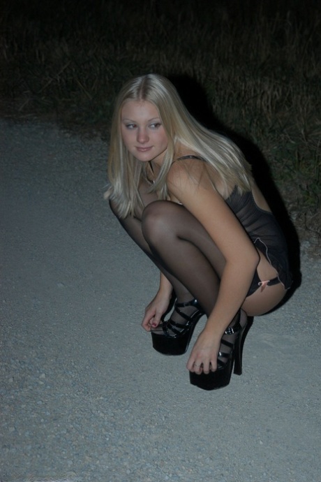 Young Blonde Tiffany Struts In Black Lingerie And Stockings On A Road At Night