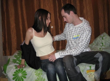 Before suckling on the bed, a college girl with dark hair and her male friend strip down.