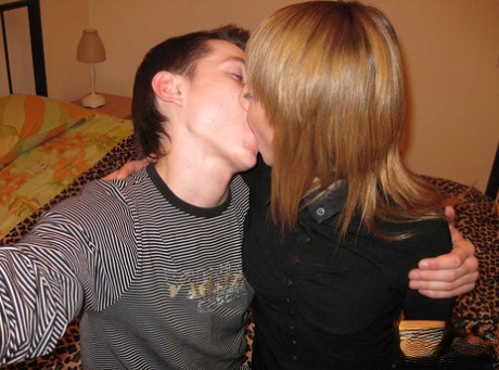 Before taking off their clothes for sex, the college girl and her boyfriend share a kiss.