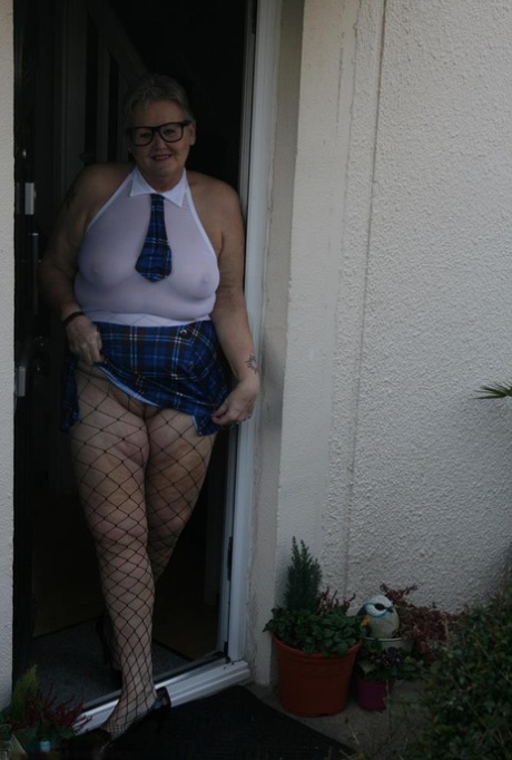 With her slutty schoolgirl attire, Fat Granny Valgasmic Exposed poses in front of the camera.