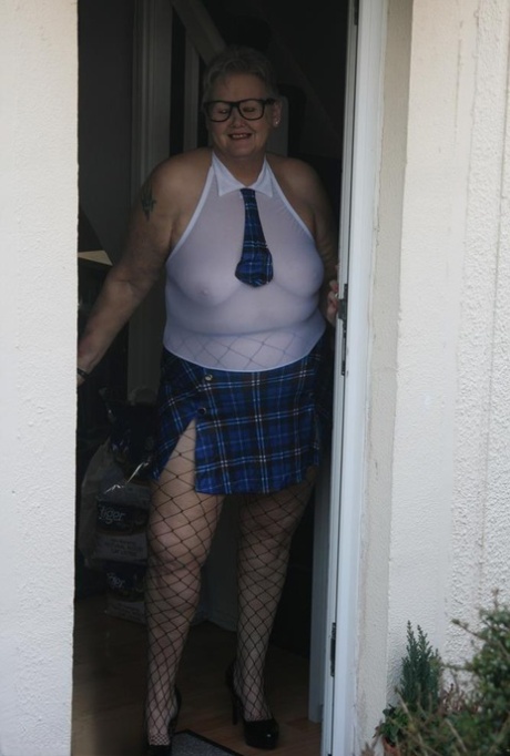 Valgasmic Exposed, a fat granny, is dressed in an exuberant schoolgirl outfit as she walks out on the street.