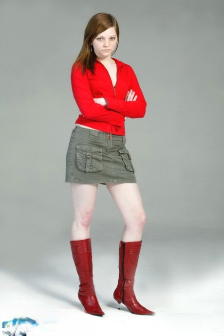 Lilly, a pale-redhead, gradually takes on the shape of a black G-string and red leather boots.