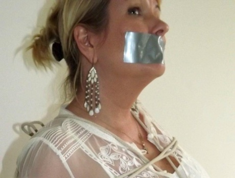 The women's tits are tied together with duct tape, while the blonde woman is silenced while wearing duct tape.