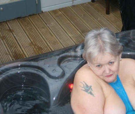 Chubby nan Valgasmic Exposed displays her tits and pussy in an outdoor hot tub.