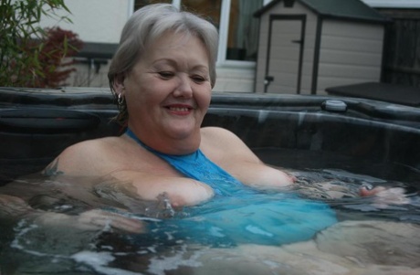 Exposed, Chubby nan Valgasmic exhibits her pussy and gestational area in an outdoor hot tub.