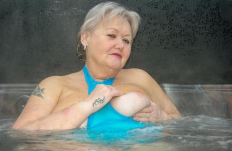 During an outdoor hot tub session, Chubby nan Valgasmic Exposed displays her vagina and excreta, including her tits and pussy.