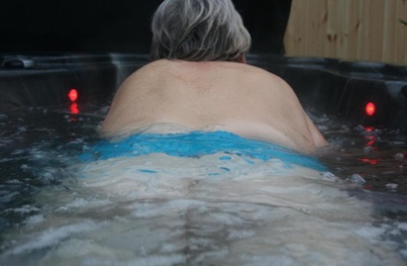While in an outdoor hot tub, Chubby nan Valgasmic Exposed displays her pugs and vagina.