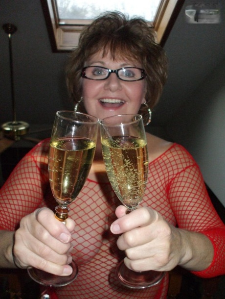 Busty Bliss, an older female, enjoys a flute of wine during oral sex in POV.