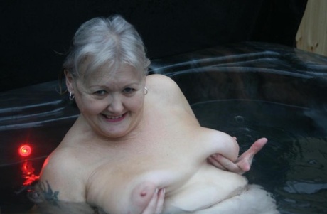 In hot tub, fat oma goes naked and then changes into nylons with heels.