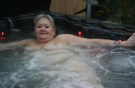 After sitting in a hot tub without clothes, fat oma transforms into nylon toppers and heels for the ultimate look.