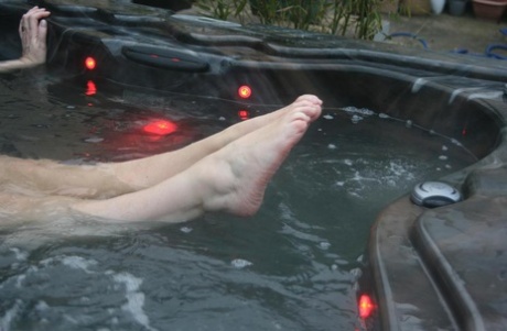 Following an hour of nudity in a hot tub, Fat Oma transforms into nyloned feet and sandals.