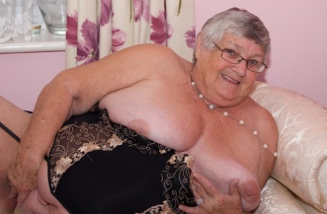 No lingerie is needed as the elderly woman with short hair works in her pussy and breast milk.