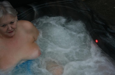During hot tubing, an elderly woman is seen playing with her breasts in Valgasmic Exposed.