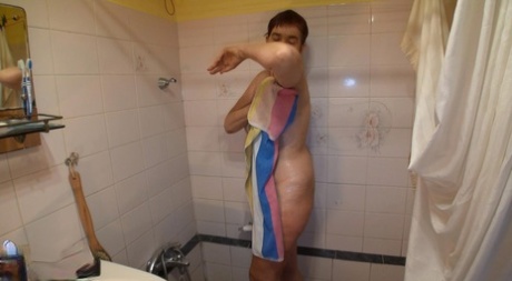 A voyeuristic person captures naked grandmother Henrieta showering.