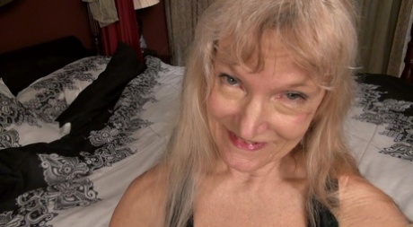 With a vibrator on her bed, nude blonde granny Cindy masturbates.