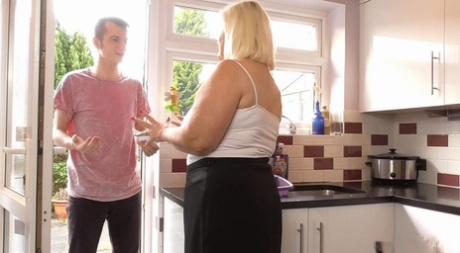 A young lad and Lacey Starr, who is an old blonde and fatty, have sexual intercourse in her kitchen.