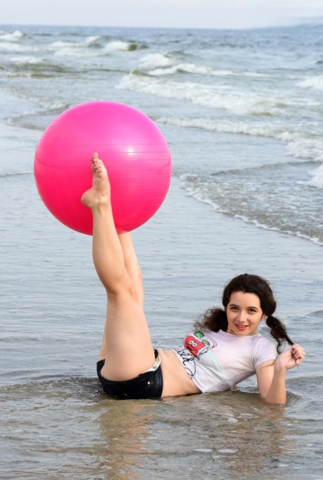 The lovely Jennifer is naked on the beach and her pigtails are in play.