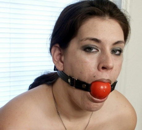 Chubby female sports a ball gag and nipple clamps while tied up in her panties